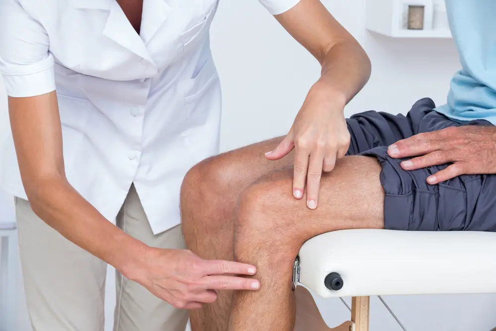Chiropractor in Chandler assessing a patients knee pain and seeing if sciatica could be the source.