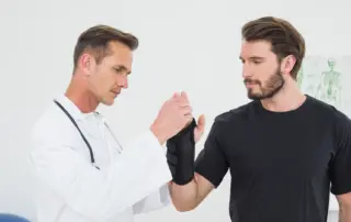 a doctor examines a man's wrist