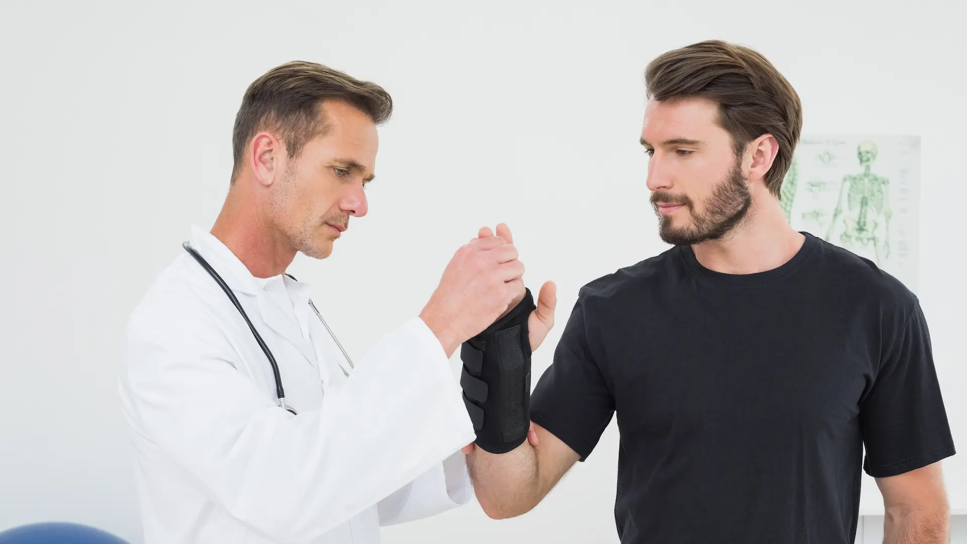 a doctor examines a man's wrist