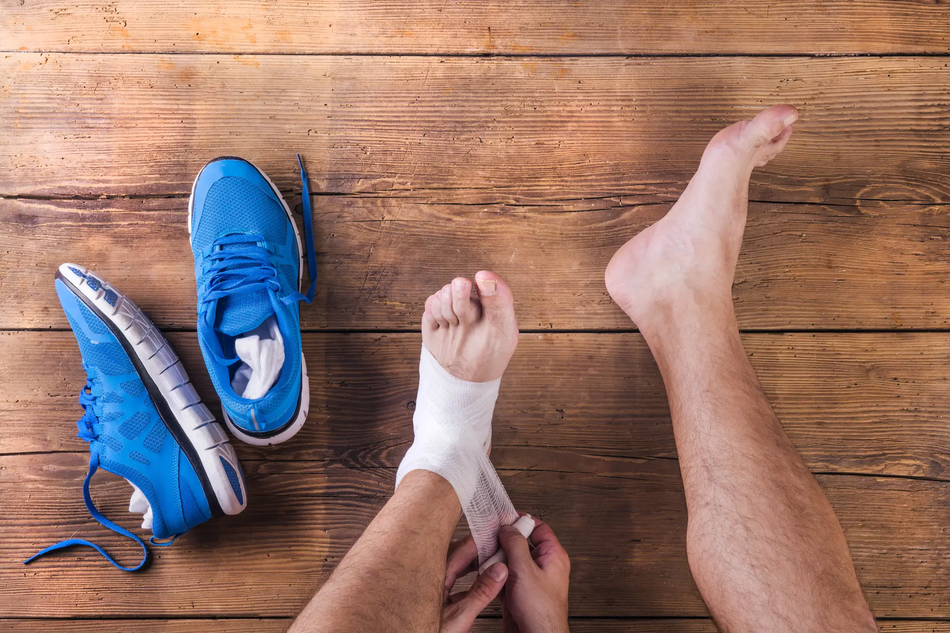 A man wraps his injured ankle