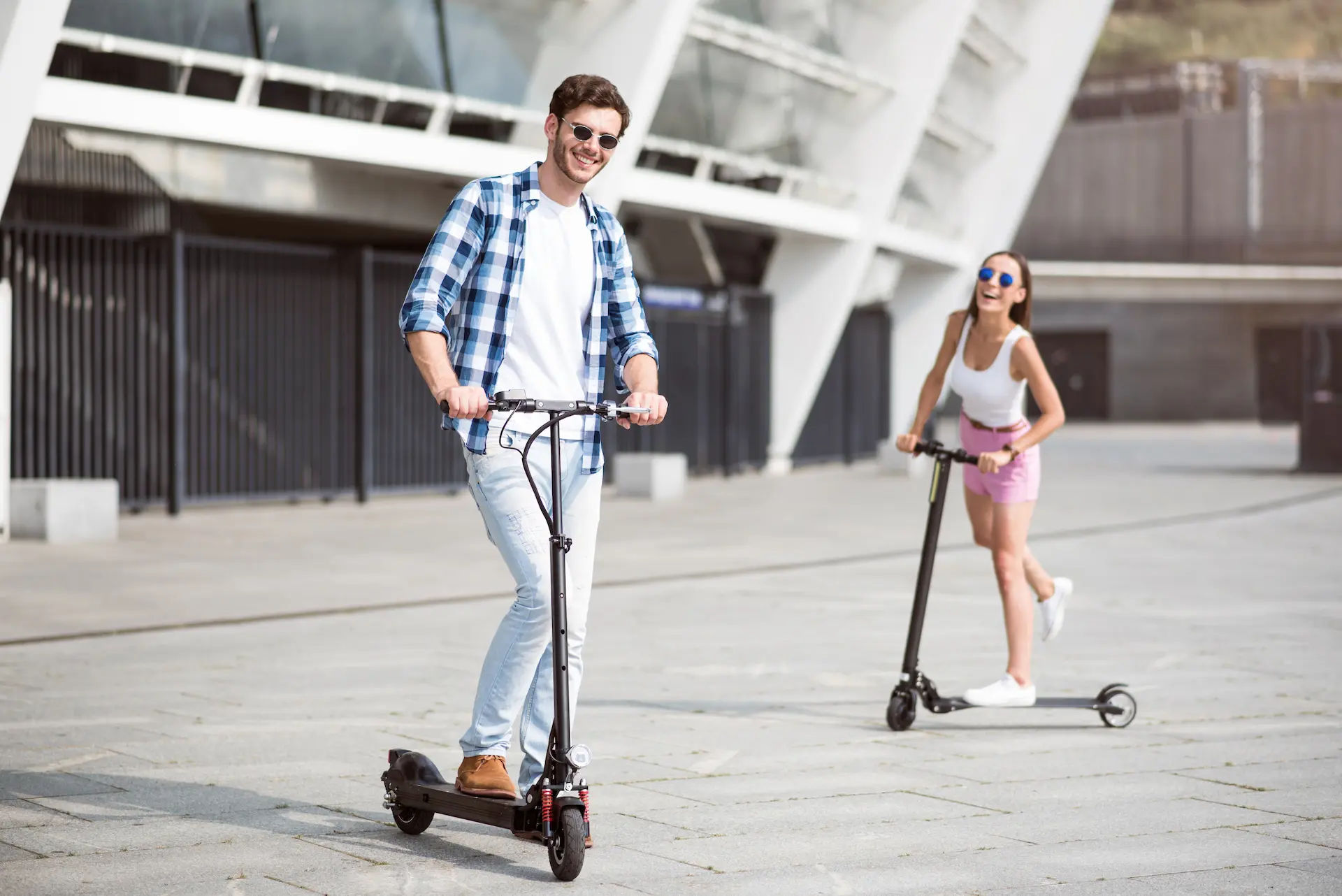 a couple rides scooters together