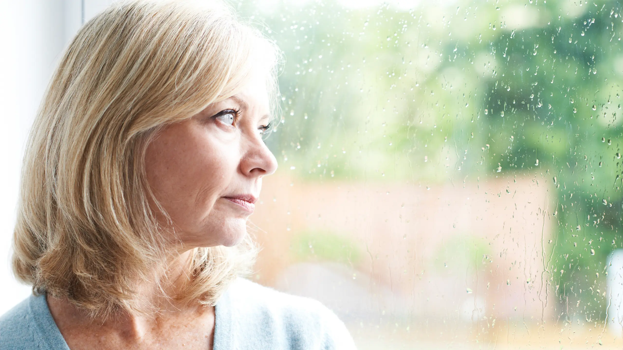 a woman looks out the window