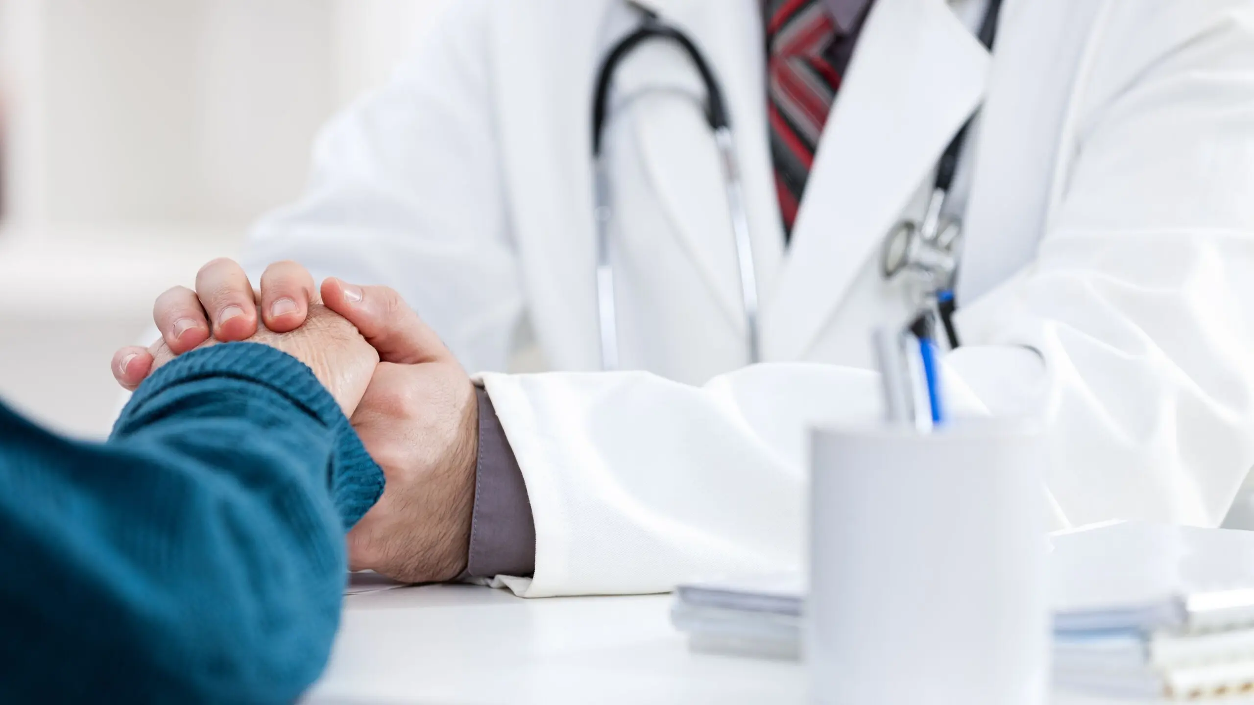 Doctor holding a patient's hand