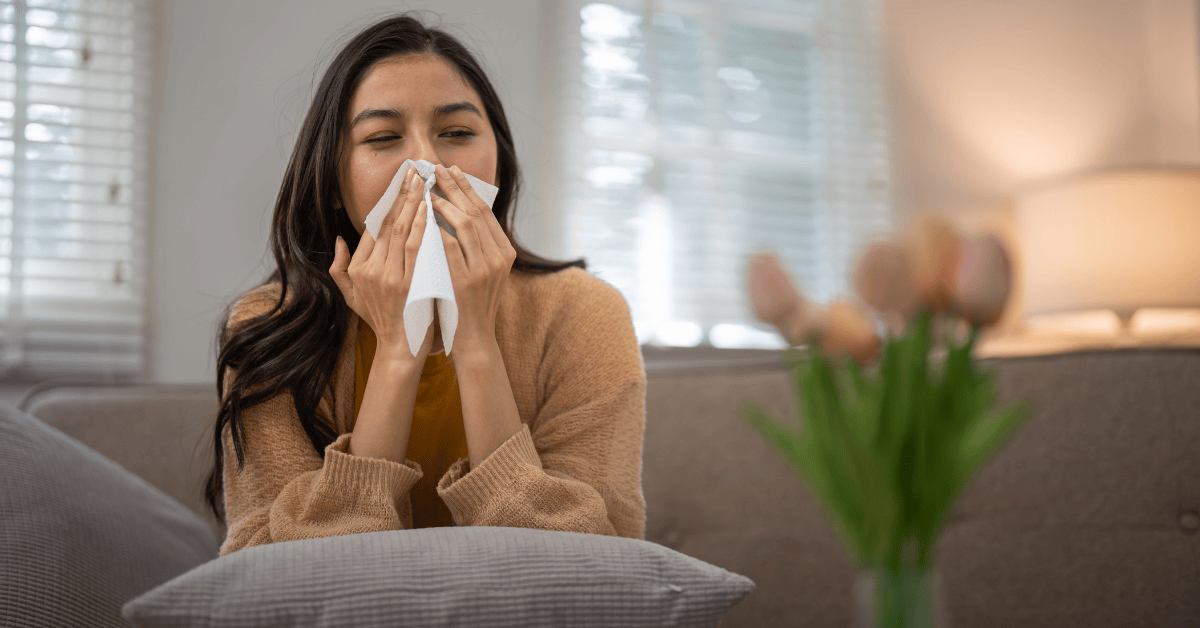 person sneezing from allergies