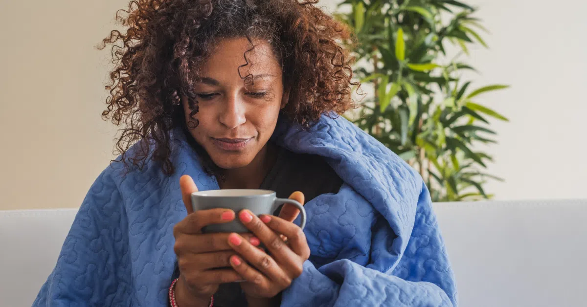 woman holding bug wrapped in blanket