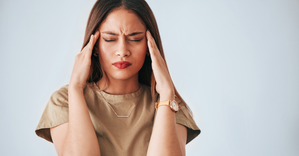 woman with hands on head with hormone imbalance