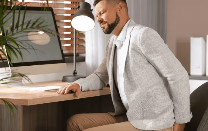 man at desk with sciatic pain