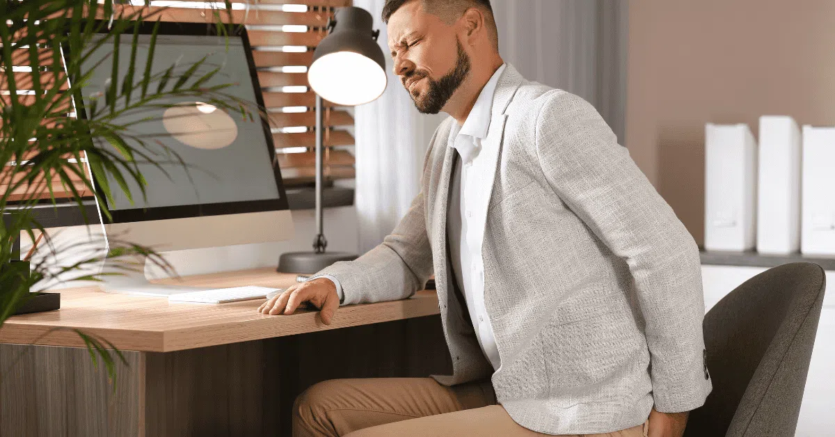 man at desk with sciatic pain