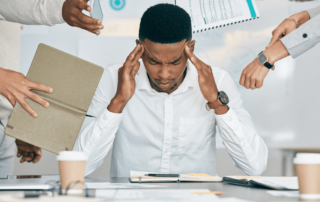 person at a desk acting stressed