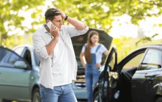 man holding head after auto accident