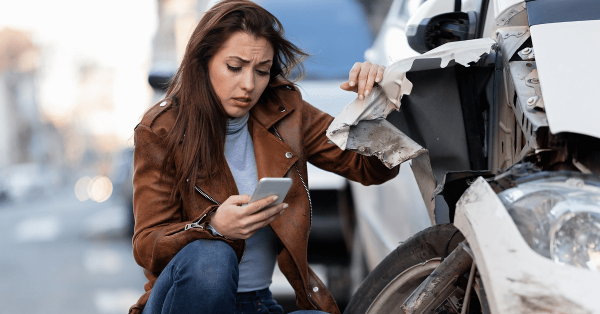 woman next to a car that has been in a car accident