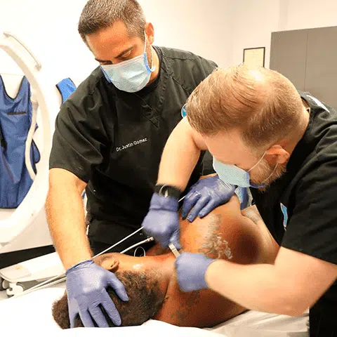 BackFit doctors performing manipulation under anesthesia Doctors performing a manual adjustment while paitient is under anesthesia