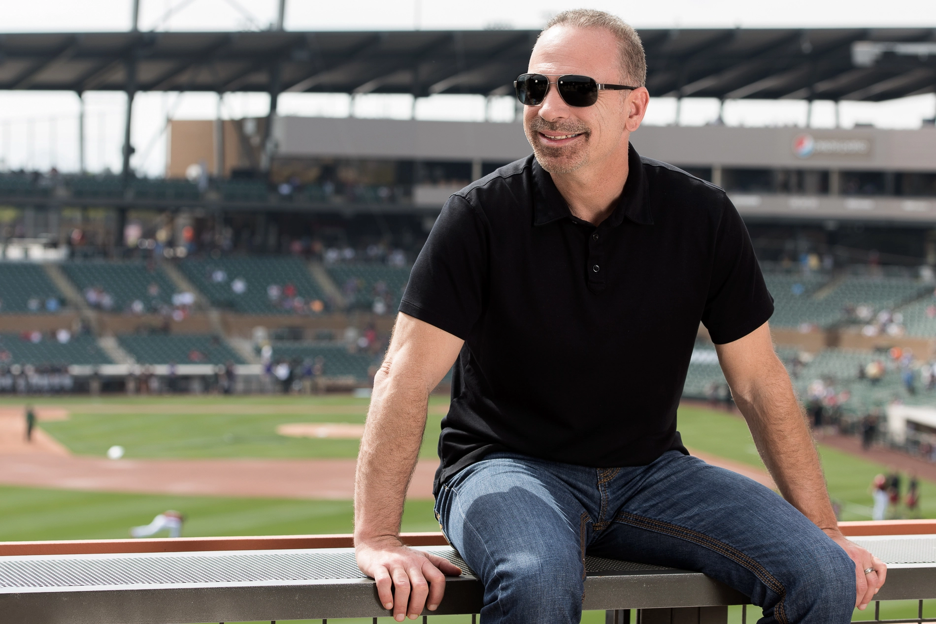 Gambo relaxing at a ballpark with sunglasses