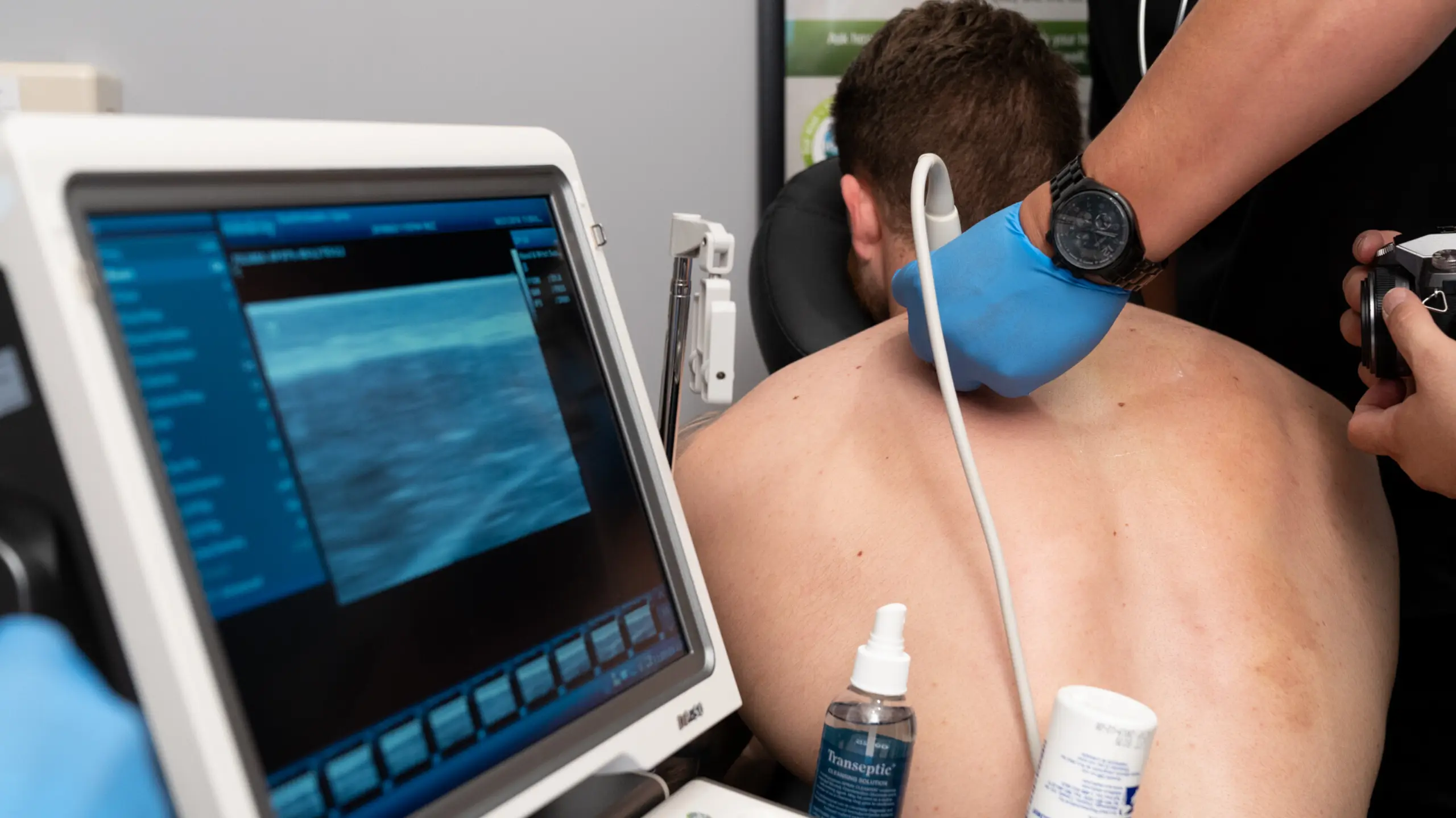 Patient receiving ultrasound during trigger point injection at BackFit