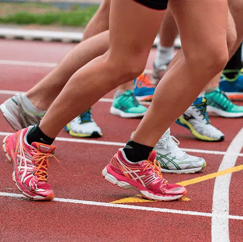 Group of people preparing to race on a track