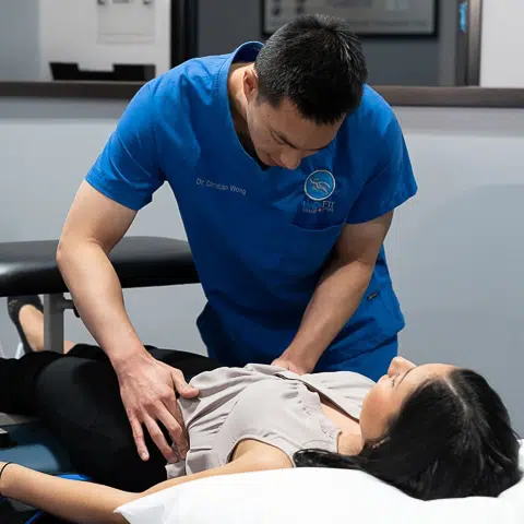 Woman getting prepped for Non-surgical Spinal Decompression Treatment at BackFit
