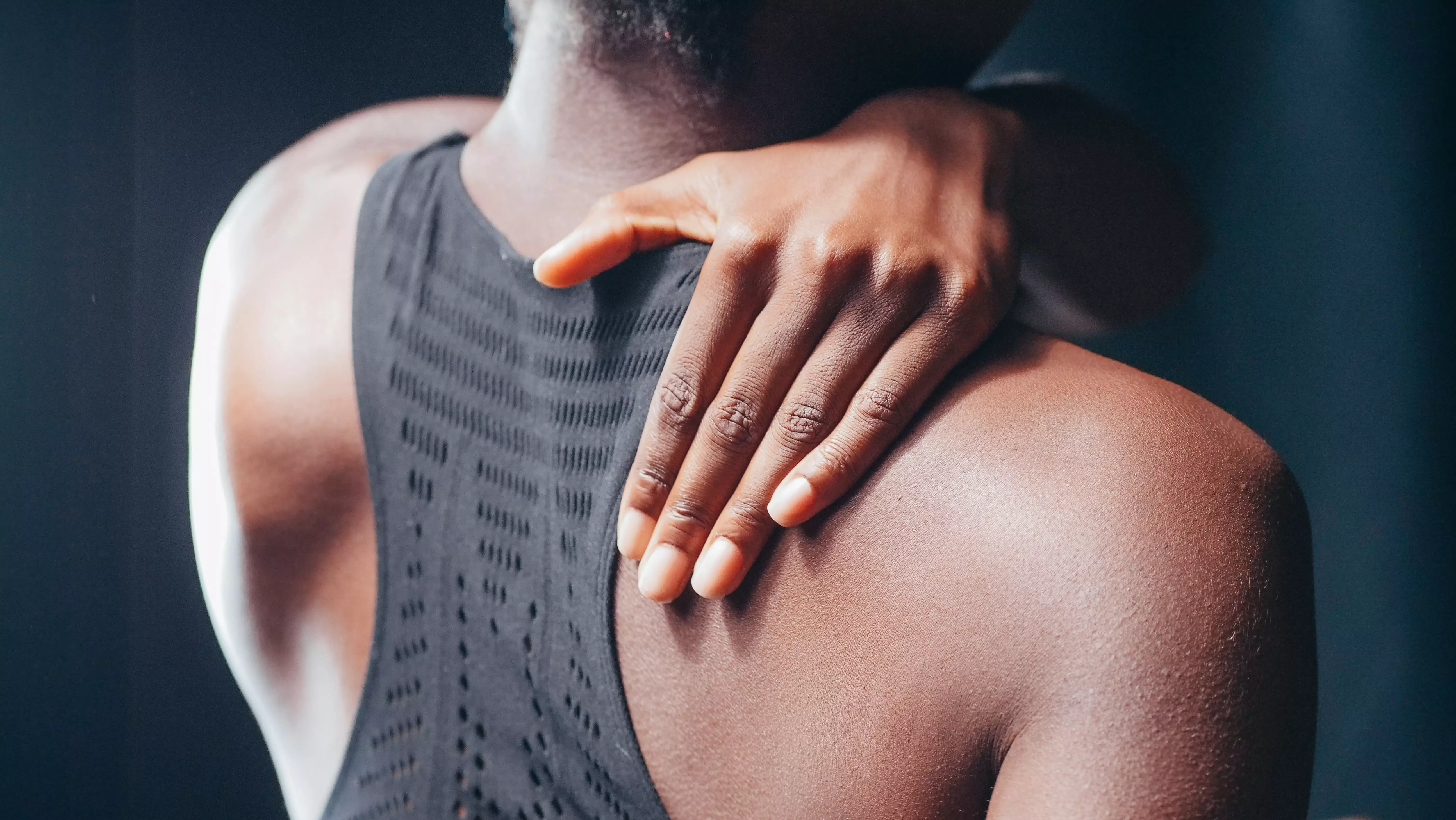 Woman holding her shoulder in pain